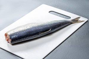 Salted herring on a white kitchen Board (Flip 2019)