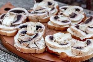 Sandwiches with mushrooms on the kitchen wooden Board