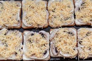 Sandwiches with slices of mushrooms, sauce and cheese