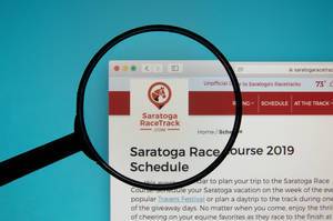 Saratoga Race Course logo on a computer screen with a magnifying glass