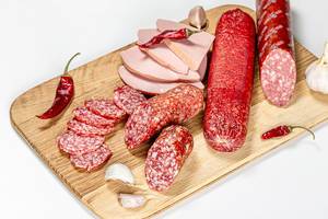 Sausage and salami of different types with chili pepper and garlic
