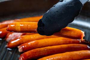Sausages frying in a skillet (Flip 2019)