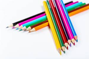 School background with colorful pencils on white background