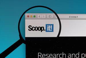Scoop.it! logo under magnifying glass