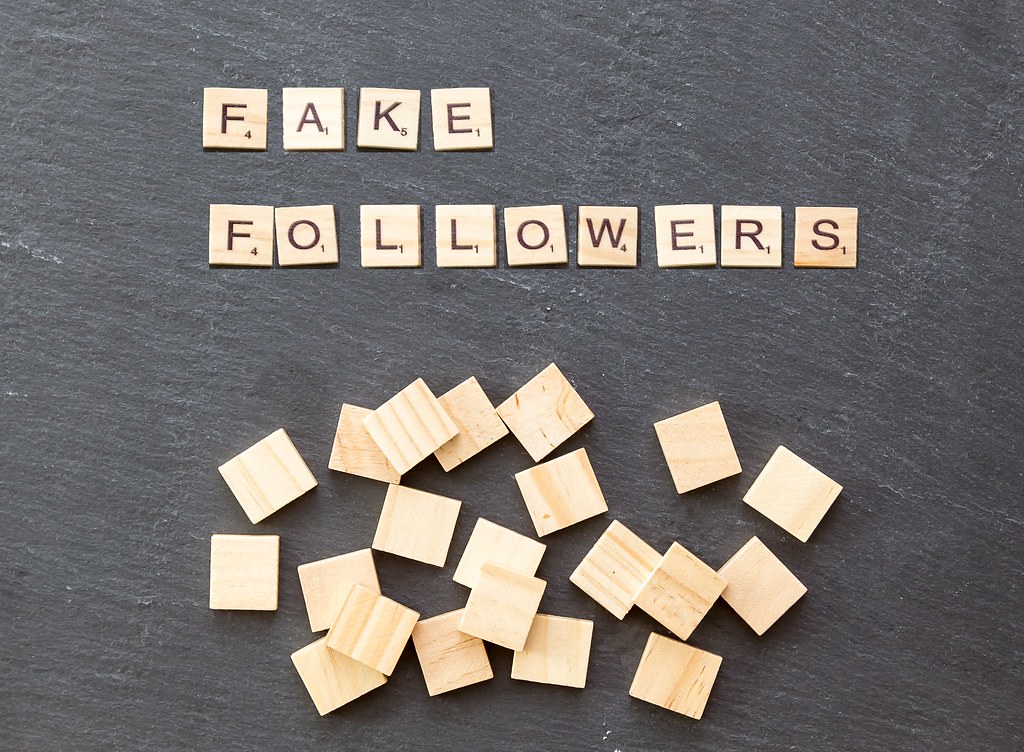 Scrabble - Fake Followers with wooden tiles on a stone background