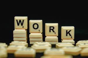 Scrabble-Steine zeigen das englische Wort für Arbeit - "Work"