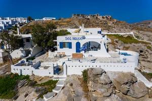 Sea House Hotel near the beach, made of white limestone, on the rocky island Paros in Greek