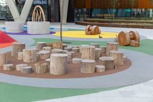 Seats made of logs at a playground