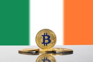 Set aus goldenen Bitcoins eingefasst von der dreifarbigen Flagge Irlands