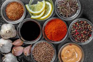 Set of different spices and sauces on a dark background (Flip 2019)
