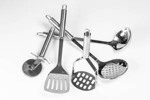 Set of metal kitchen utensils on white background (Flip 2020)