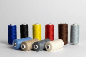 Sewing thread of different colors isolated on white