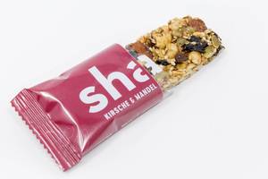 Share Foods - Bio Nussriegel mit Kirsche und Mandel auf weißem Hintergrund