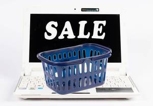 Shopping basket on a laptop with sale text