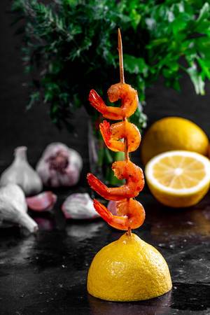 Shrimp on a wooden skewer with lemon and herbs (Flip 2019)