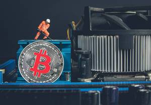 Silver Bitcoin and miner on a Mother board
