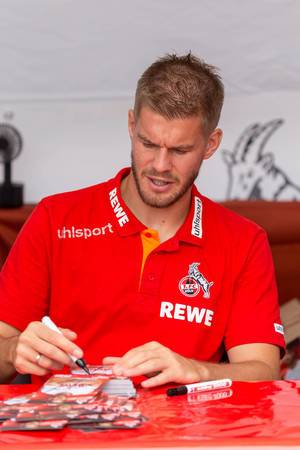 Simon Terodde signing autograph cards for fans