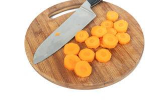 Sliced Carrot on the round wooden board with knife (Flip 2019)