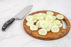 Sliced Cucumber on the round wooden board (Flip 2019)