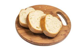 Sliced domestic homemade bread on the round wooden board