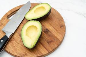 Sliced fresh Avocado on the wooden board (Flip 2019)