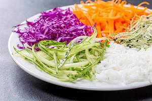 Sliced fresh vegetables and rice on a plate closeup (Flip 2019)