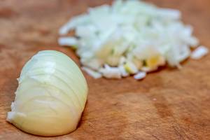 Sliced onions on a wooden background.