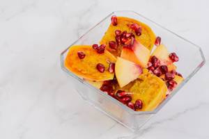 Sliced Peach with Pomegranate in the bowl