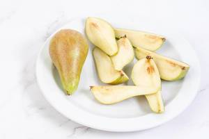 Sliced Pears on the plate above white background