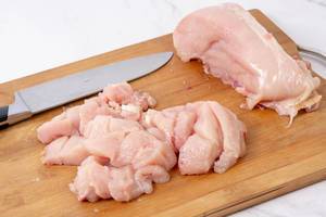 Sliced Raw Chicken meat on the cutting board (Flip 2019)