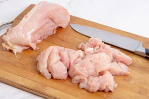 Sliced Raw Chicken meat on the cutting board