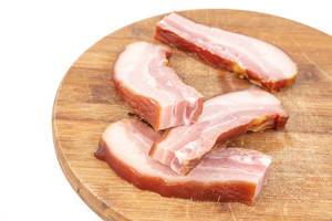 Sliced Raw homemade Pork Bacon on the cutting wooden board (Flip 2019) (Flip 2019) (Flip 2019)