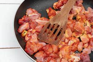 Sliced raw Meat with Paprika Spices in the frying pan