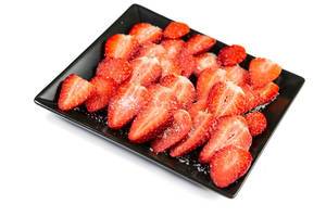 Sliced Strawberries on the black square plate