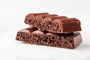 Slices of porous chocolate on a light background