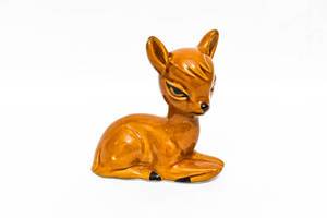 Small fawn figurine on white background