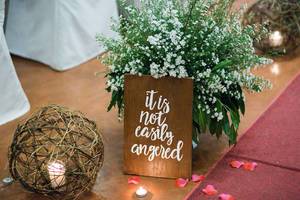 Small signage decoration at a wedding aisle
