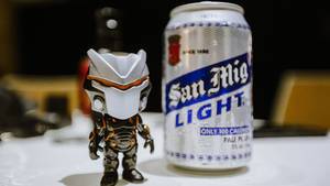 Small Toy beside a Can of Beer