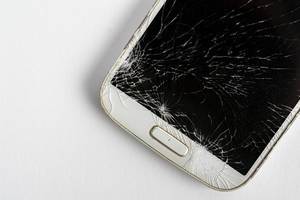 Smashed mobile phone on the table with copy space (Flip 2019)
