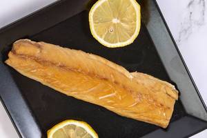 Smoked Mackerel fish with Lemon served on the plate