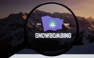 Snowbombing Festival logo on a computer screen with a magnifying glass