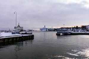 Snowy sea port of Helsinki with a cloudy bright sky