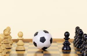 Soccer ball of chess pieces on the board