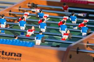 Soccer fans playing table football outdoors