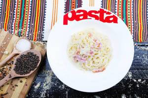 Spaghetti carbonara with peppercorns and salt, Italian cuisine