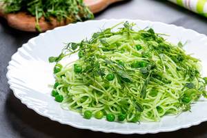 Spaghetti with fresh micro-green peas and young peas