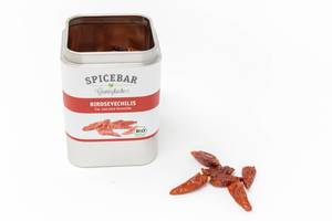 Spice can by  Spicebars - Gewürzküche with red and white colors, contains dried Birdseye chili peppers, for spicing up dishes, on a white background