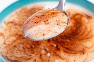 Spoon with cottage cheese, yogurt and cocoa, close -up