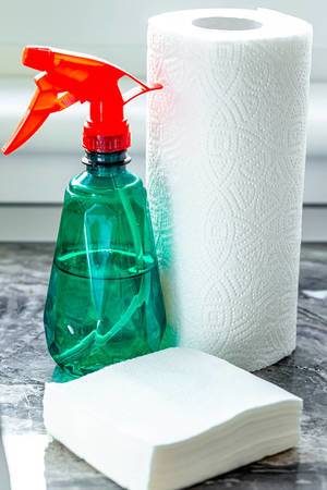 Spray in a plastic bottle with paper towels and napkins