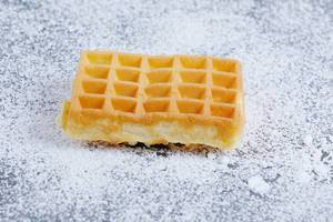 Square waffle on powdered sugar (Flip 2019)